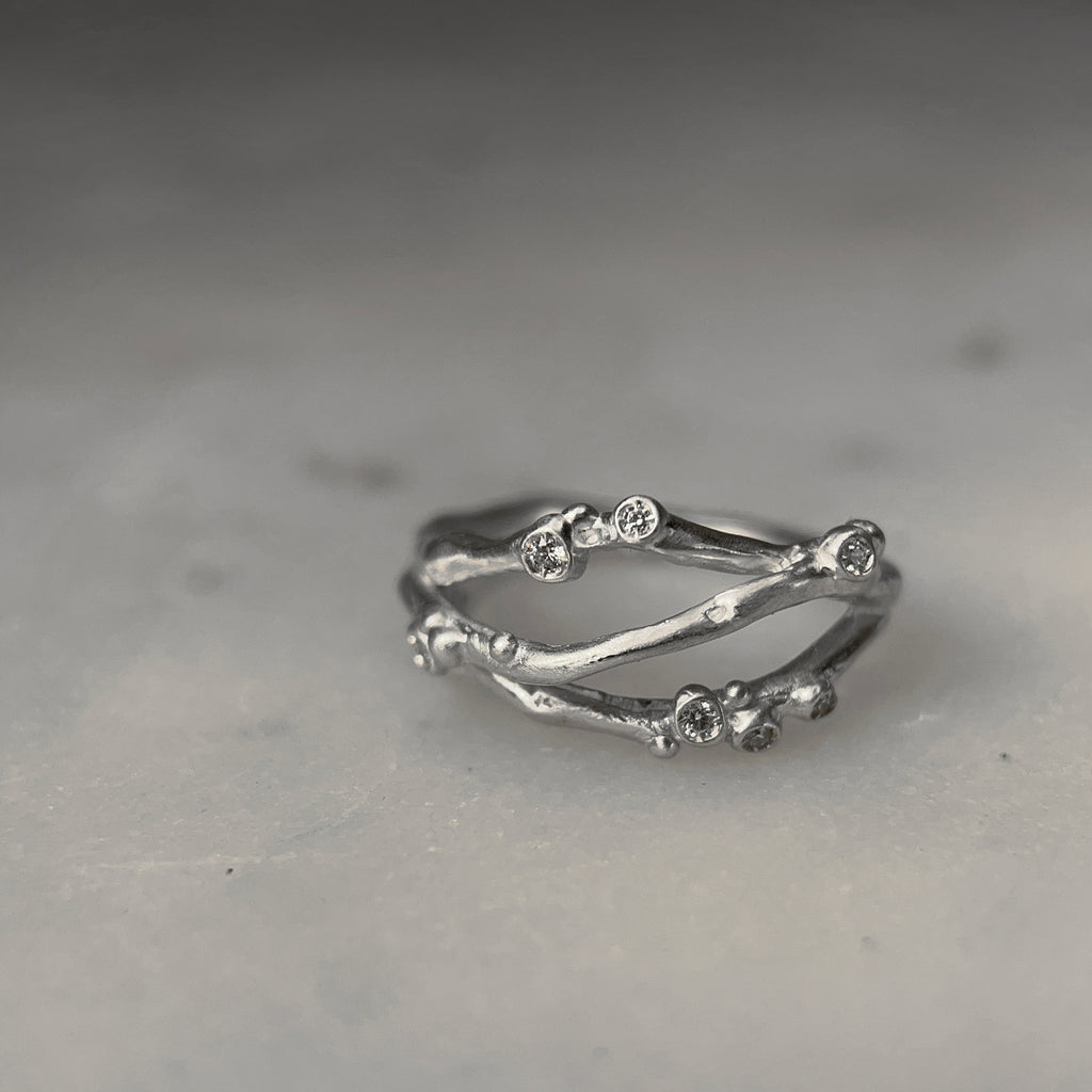Organic, branch-like ring with three branches. Seven tiny diamond buds per ring. Shown in silver.