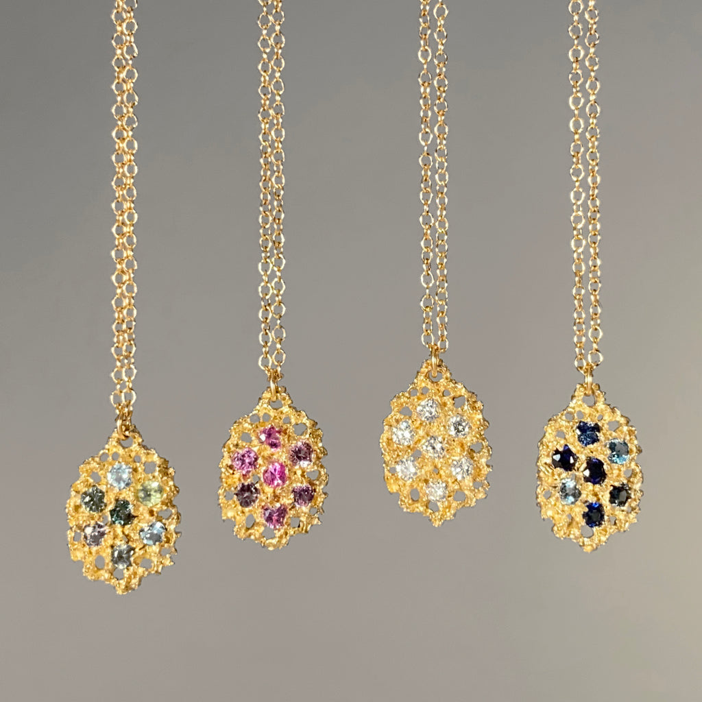 Textured, lacy, lemon-shaped pendant, available in yellow gold with a variety of stone options