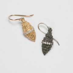 Textured, marquise-shaped earring on wire; diamond stripe bissects piece left to right across middle; shown in polished gold and blackened silver