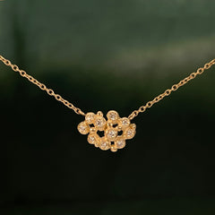 Necklace is cluster of 10 tiny diamond "buds"; shown in yellow gold with a satin finish