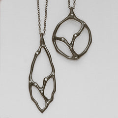 Coral-tree inspired round and elongated pendants with diamonds; shown in blackened silver