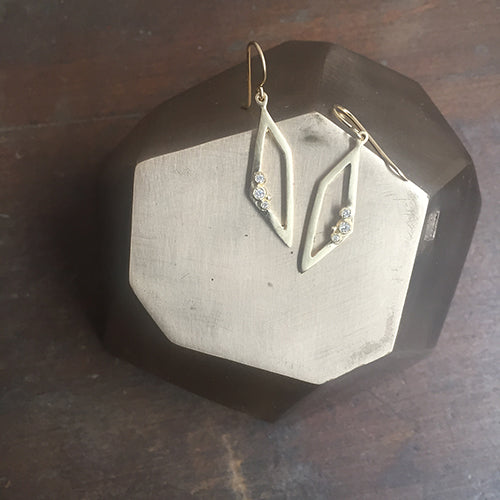 Outline of trapezoid; 3 diamond buds; earring on wire; shown in yellow gold