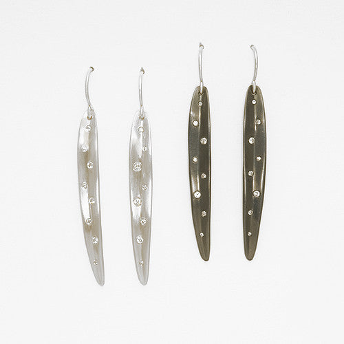 Medium-length, slightly concave, leaf-like shaped earring with scattered small diamonds in various sizes; shown in matte and blackened silver options