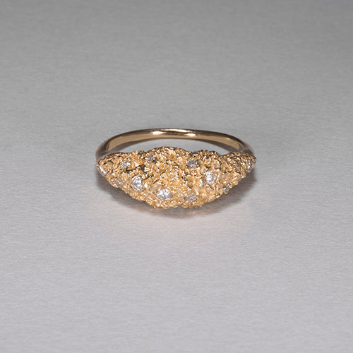 Textured, mountain-like mass on top of band, studded with diamonds