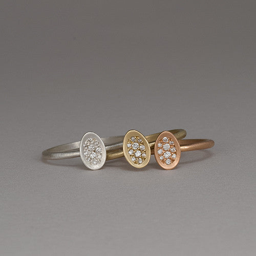 Ring with tiny concave egg-shaped topper with pavé diamonds; shown in 14k yellow, 14k rose, and 14k white