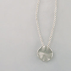 Soft, round, organic, slightly concave pendant; hilly edges slope into middle