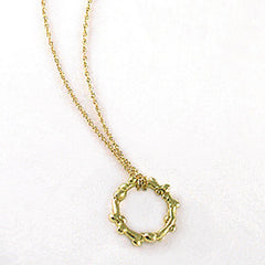 Branch-like necklace in round shape; organic and asymmetrical; shwon in poihsed yellow gold