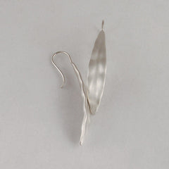 Elongated leaf-shaped earring with fixed wire; edges of leaf are ruffled, or hilly; satin finish; shown in silver