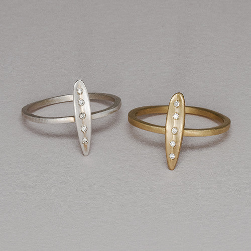 Very small, narrow leaf ring; shape is slightly convex with vertical crease in center; shown in silver and yellow gold; 5 diamonds in crease