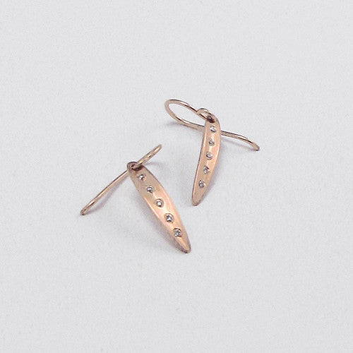 Very small, narrow leaf earring on wire; shape is slightly convex with vertical crease in center; shown in rose gold; 5 diamonds run up an down crease