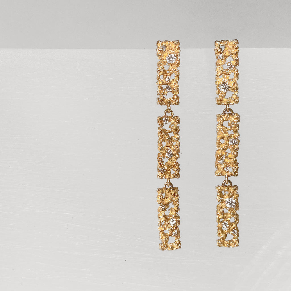 Post earring; three rectangkes with texture and negative space and diamonds, connected with jump rings