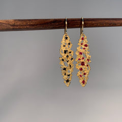 Textured ellipse-shaped earring on wire, shown with black diamond and ruby options 