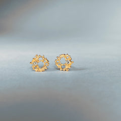 Lacy, textured, tiny stud; each has a white diamond set off-center