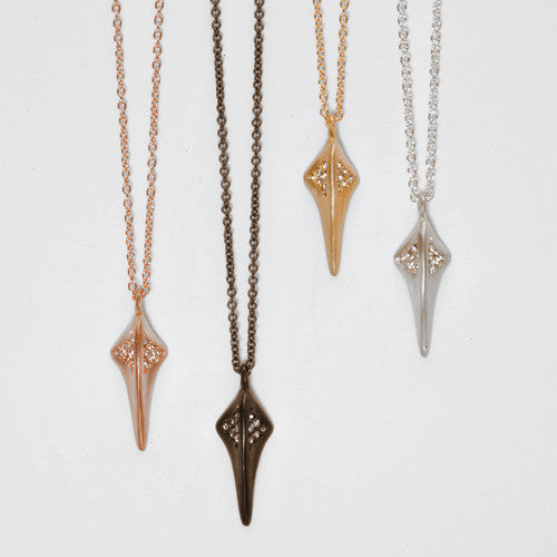 Stylized beak necklace with triangular cluusters of diamonds at top of beak, on either side of center line; shown in silver and blackened silver, and rose and yellow gold