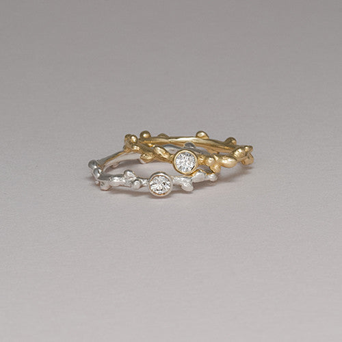 Branch-like ring with center diamond; shown with largest stone option of 12 pt, in polished gold and polished silver options