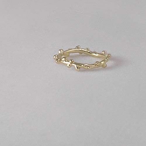 Branch-like ring; organic and asymmetrical; shwon in poihsed yellow gold