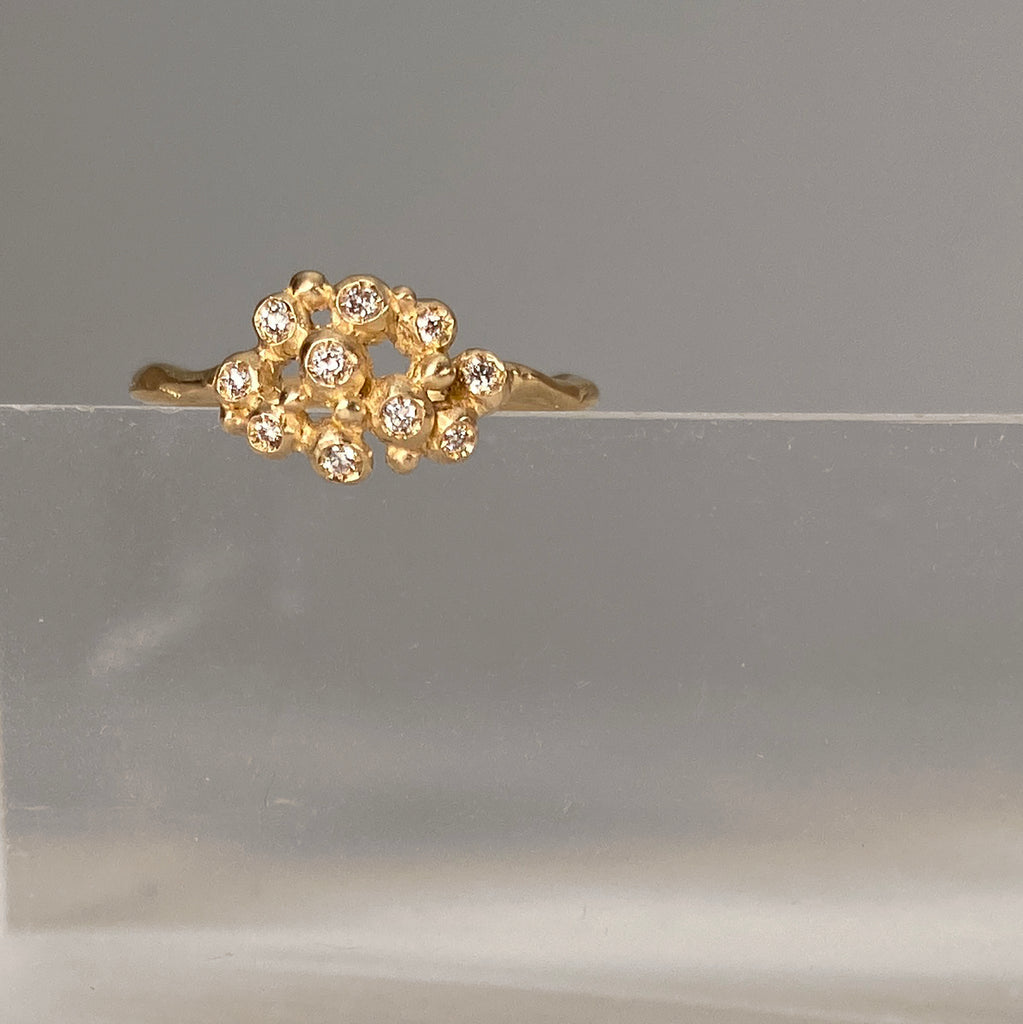 Ring with cluster of 10 tiny diamond "buds"; shown in yellow gold with a satin finish