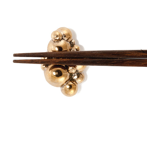 Solid bronze chopstick rest that looks like bubbles