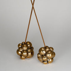 Solid bronze incense holder that looks like bubbles; textured and polished; shown with incense