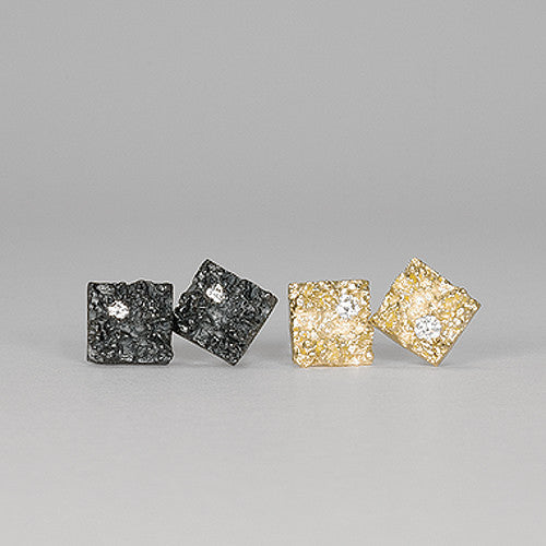 Thick, textured square stud with diamond in 1 corner; shown in blackened silver and polished gold