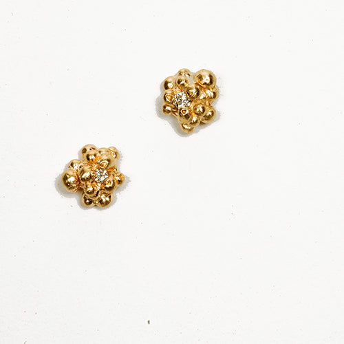 Small studs of gold granules with diamonnd off-center