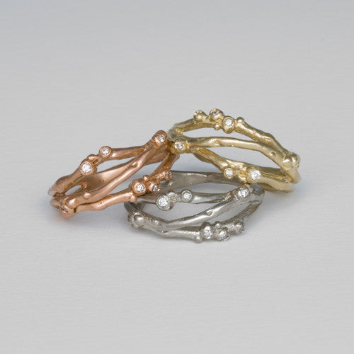 Organic, branch-like ring with three branches. Seven tiny diamond buds per ring. Shown in yellow gold, rose gold, and white gold.
