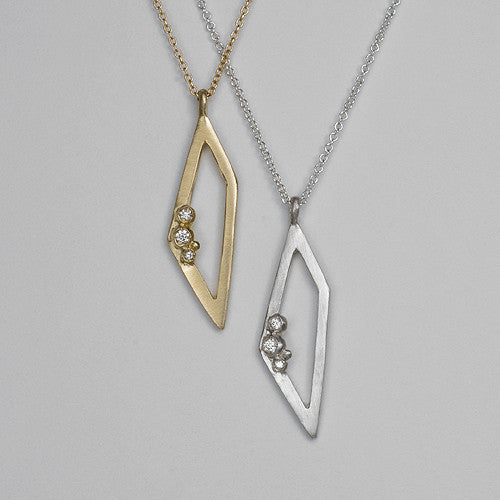 Outline of trapezoid; 3 diamond buds; pendant; shown in yellow gold and silver