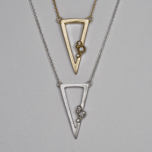Outline of triangle; 3 diamond buds; pendant shown in yellow gold and silver