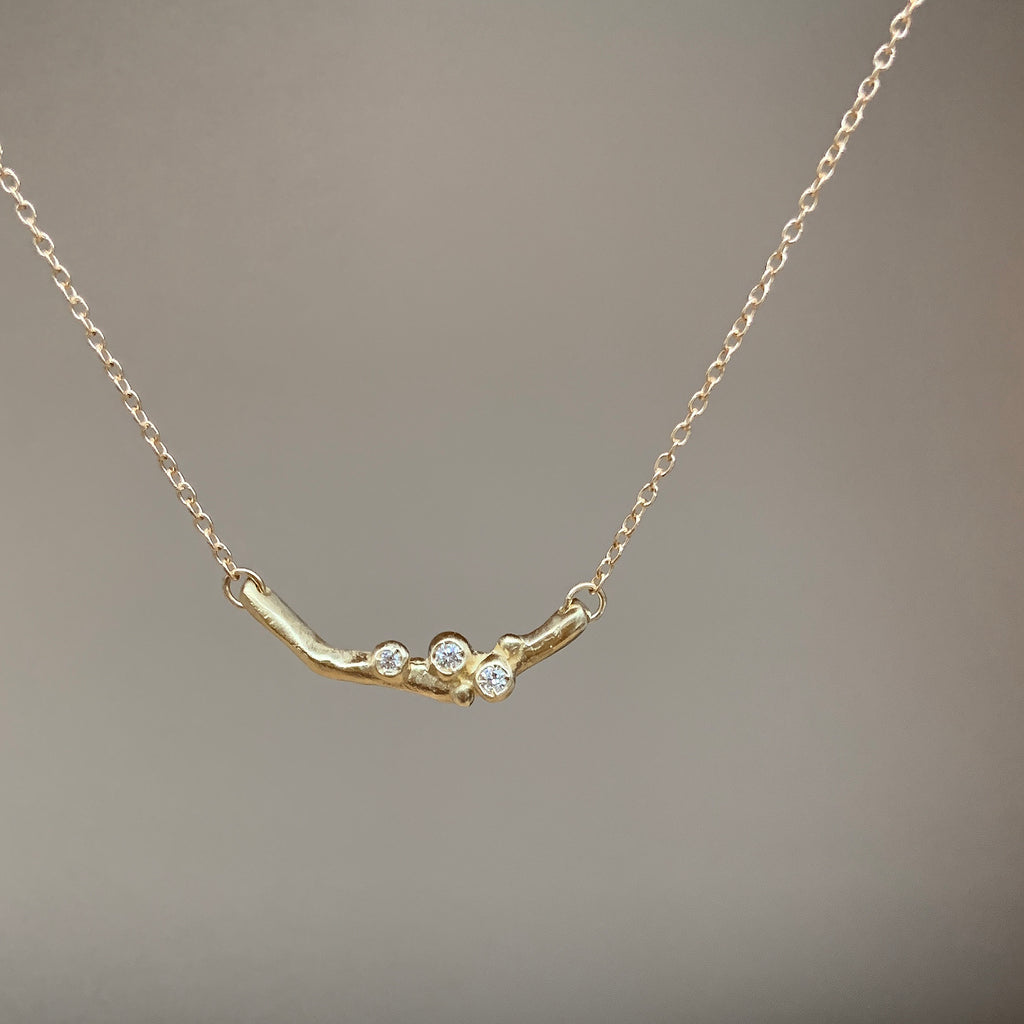 Single short branch with 3 diamond buds on chain; horizontal; shown in yellow gold