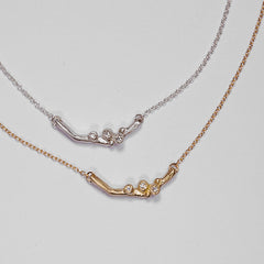 Single short branch with 3 diamond buds on chain; horizontal; shown in yellow gold and silver
