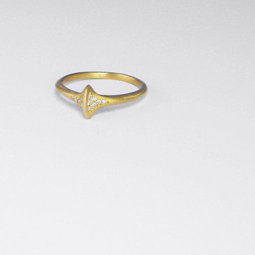 Diamond-shaped ring with raised center line; pavé diamonds on either side of center line; shown in yellow gold