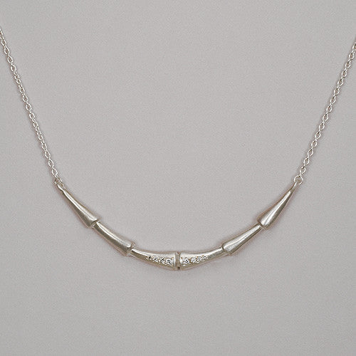 long horizontal necklace with diamonds extending on either side of the center line