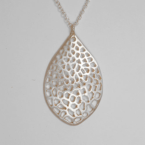 leaf-shaped, slightly convex pendant; has overall pattern made by organic cutouts; shown in silver