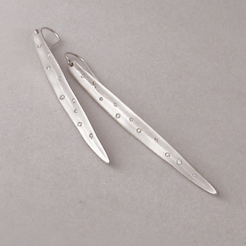 Long, slightly concave, leaf-like shaped earring with scattered small diamonds in various sizes