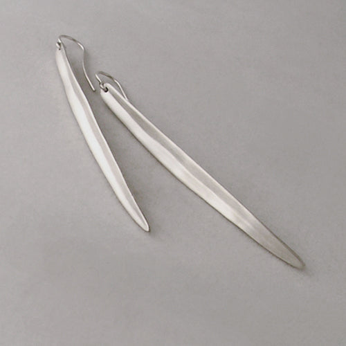 Long, slightly concave, leaf-like shaped earring; shown in silver