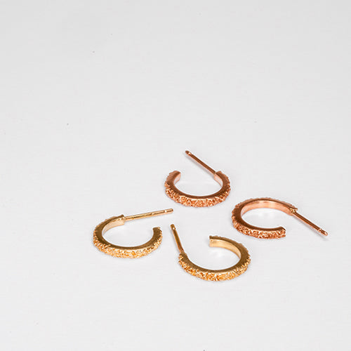 Slim, textured, hoop earring with squared-off edges and polished sides