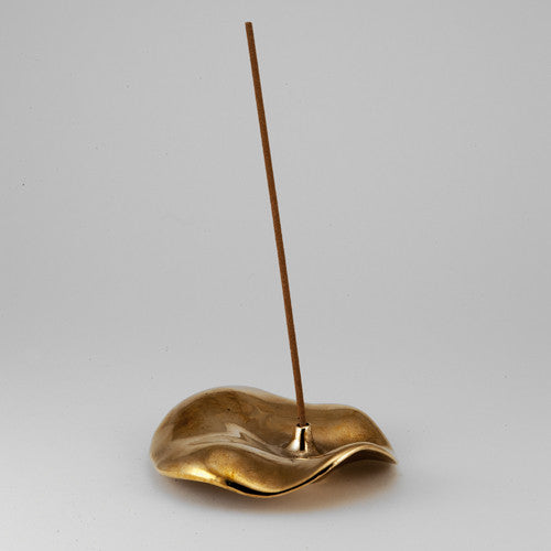 Low profile incense holder in cast bronze with flared, ruffled, skirt-like design