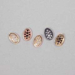 Tiny concave egg-shaped stud with pavé diamonds; shown in various finishes