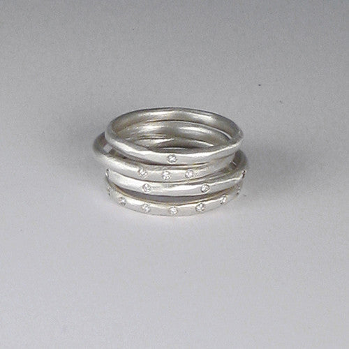 Very slim, gently faceted band, shown with various numbers of diamonds