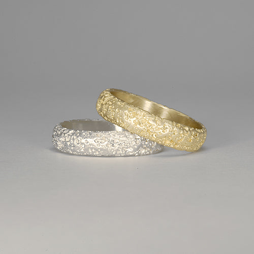 Soft, domed band with satin finish over rock-like texture