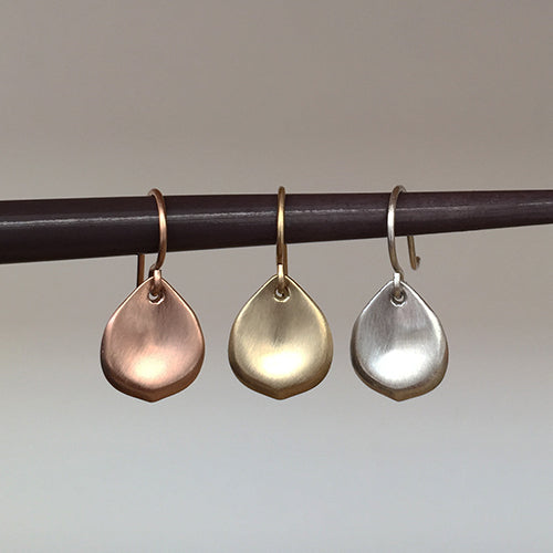 Small, stylized rose petal earring on wire; shown in three metals: silver, yellow gold, rose gold