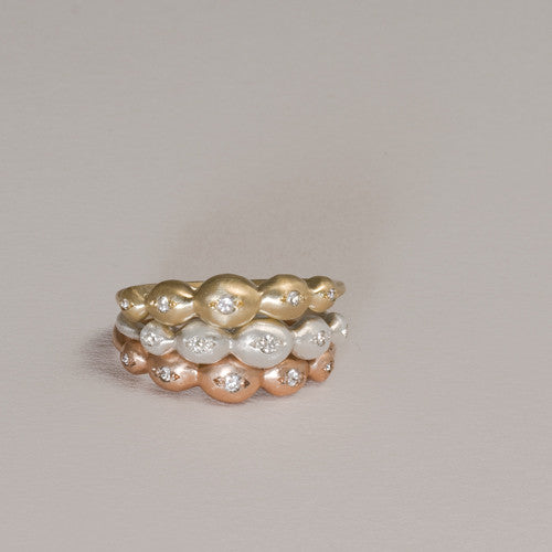 Scalloped, horizontal ring with a diamond in each of the 5 scallops