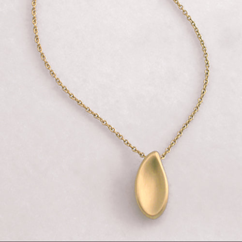 Paisley-shaped, substantial concave shell pendant; soft; hidden bail 
