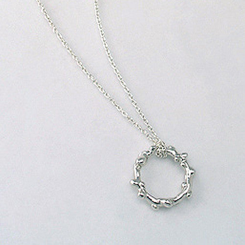 Branch-like necklace in round shape; organic and asymmetrical; shwon in poihsed silver