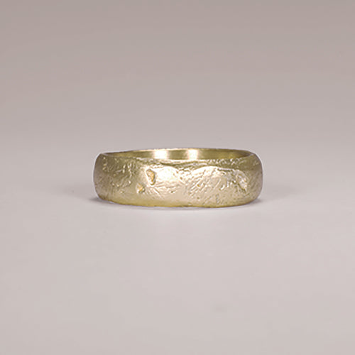 Substantial band with soft look and slightly rounded edges; details like scratches and tiny holes give worn appearance